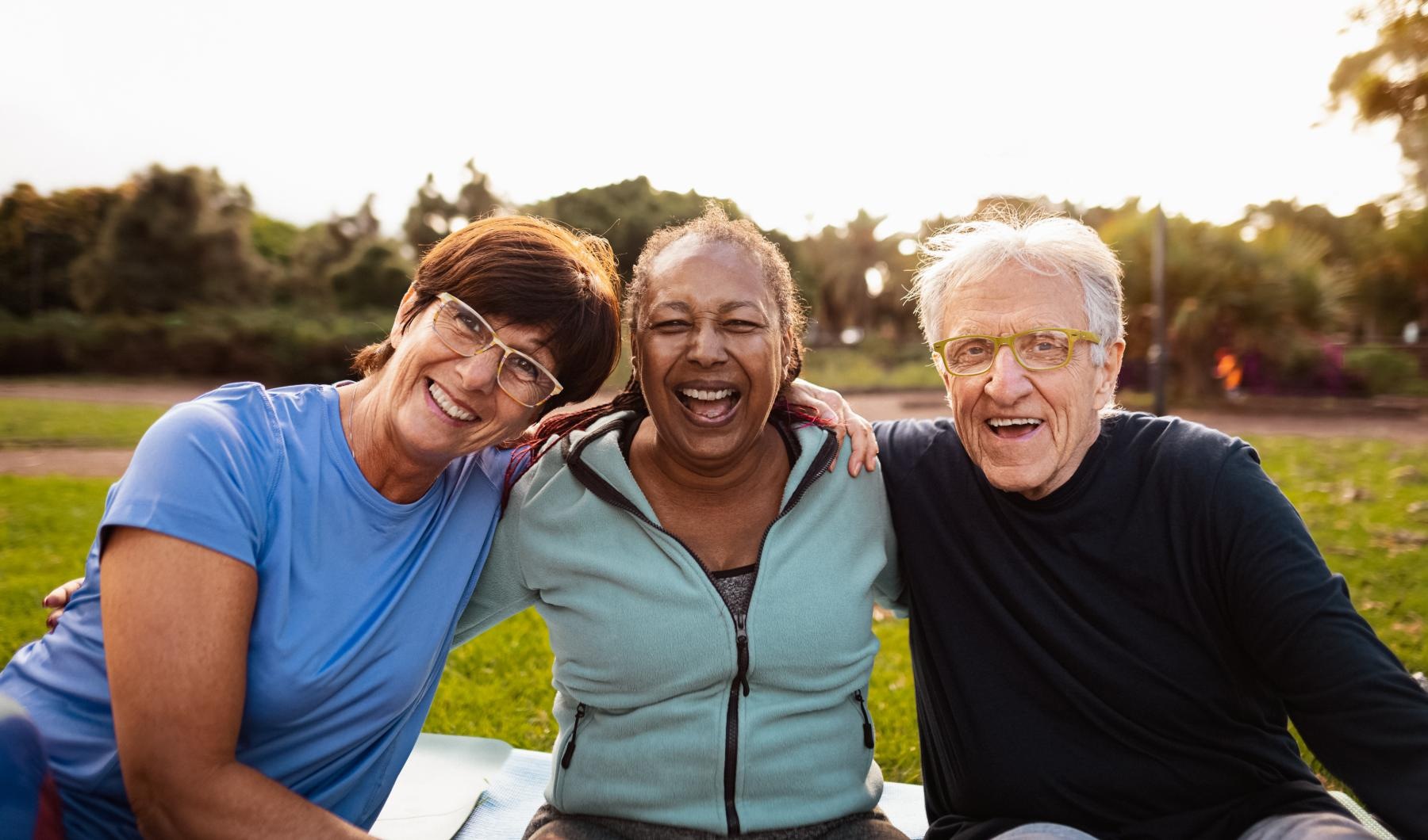a group of people sitting together smiling