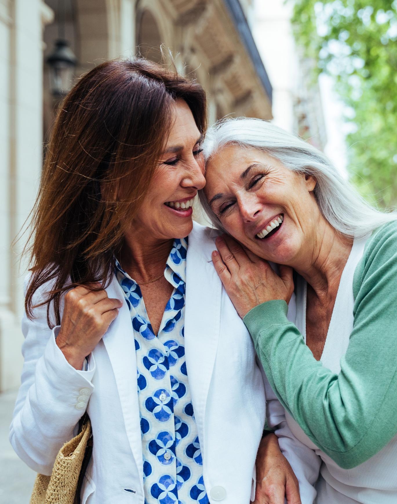 a woman laughing with another woman