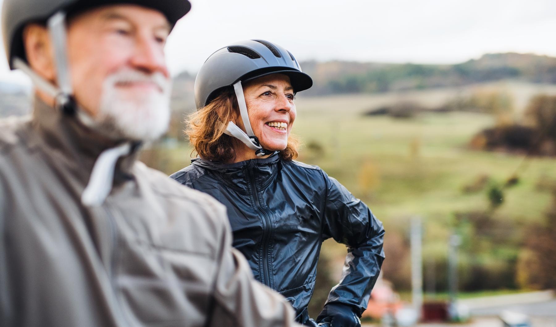a man and woman wearing helmets